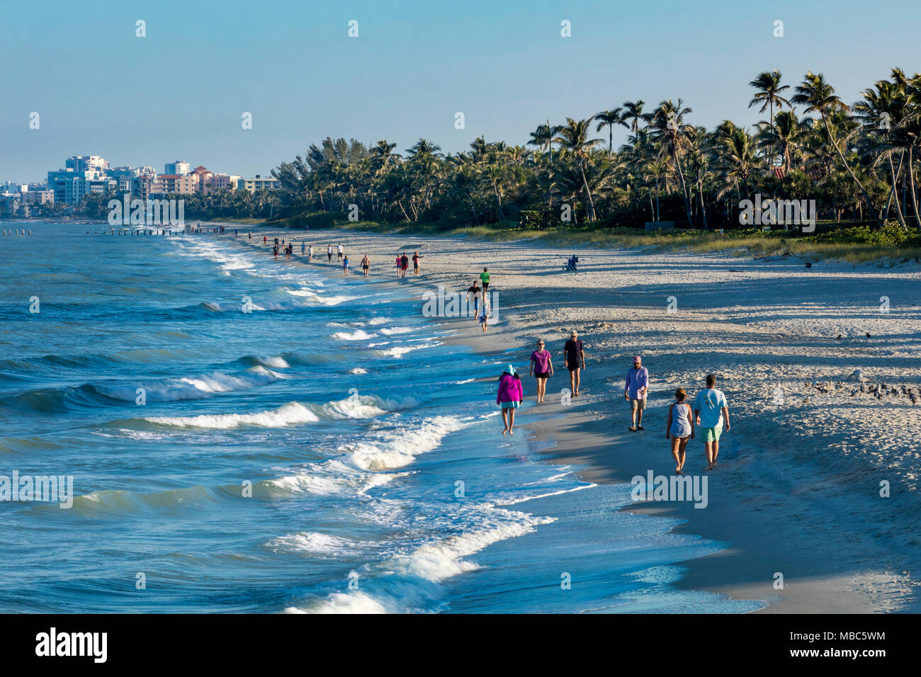 Early morning walk on the beach of Florida's Gulf Coast near the Naples Pier, Naples, Florida, USA Stock Photo