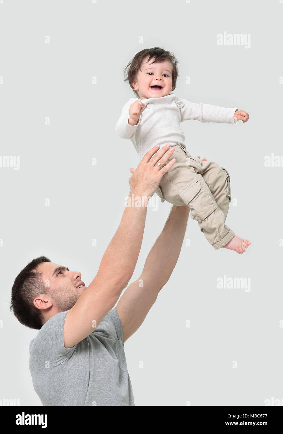 Father tossing baby in the air Stock Photo Alamy