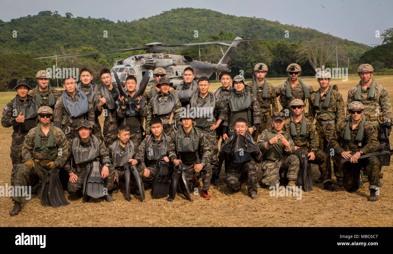 U.S. and Republic of Korea reconnaissance Marines train together during a helocast exercise at the Sattahip district in the Chonburi province, Kingdom of Thailand, Feb. 12, 2018. Marine Heavy Helicopter Squadron 466 ‘Wolfpack’ supported the helocast training with the U.S., Thai, and ROK Marine Corps reconnaissance teams. The CH-53E Super Stallion is assigned to HMH-466, Marine Aircraft Group 16, 3rd Marine Aircraft Wing, currently forward deployed under the unit deployment program with MAG-36, 1st MAW, based out of Okinawa, Japan. Exercise Cobra Gold 2018 is an annual exercise conducted in the Stock Photo