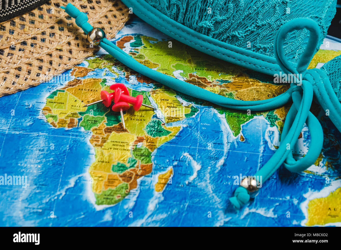 Travel Destination Points on World Map Indicated with Colorful Thumbtacks, Red Ribbon and Shallow Depth of Field. Stock Photo