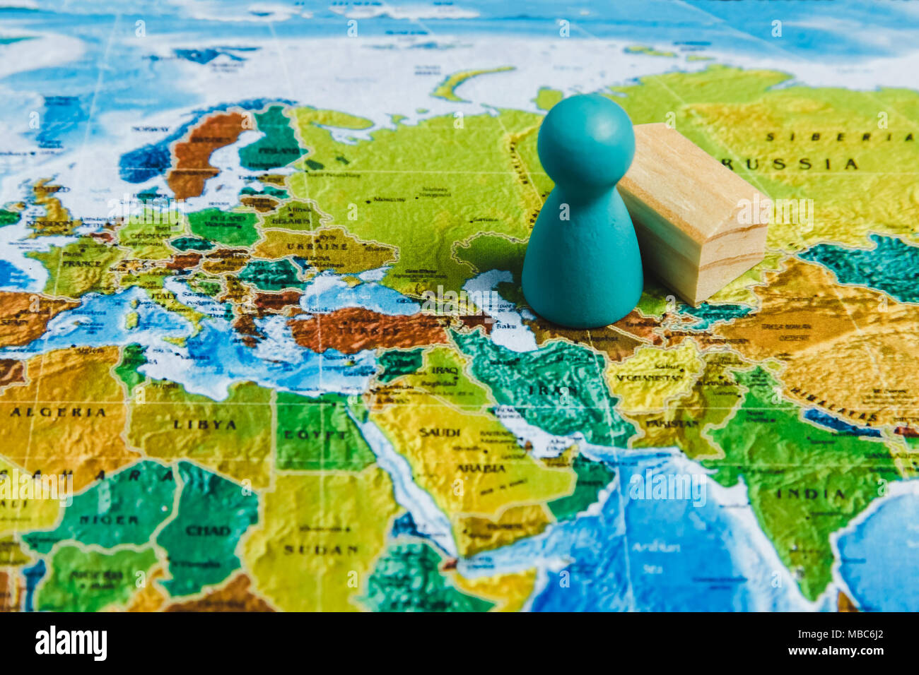 Travelling Concepts. Traveler Miniature Mini Figures Standing on World Map. Stock Photo