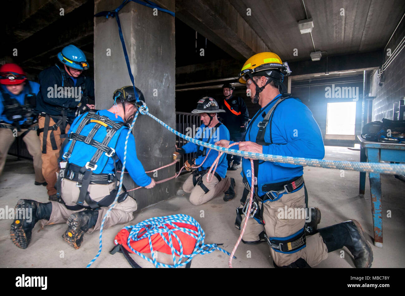 Firefighters from the Mississippi Task Force, Urban Search and Rescue team secure a system of ropes to enable their teammate’s escape from a simulated collapsed building during the training exercise PATRIOT South 18, at Camp Shelby, Miss. on Feb. 14, 2018. PATRIOT South, a joint-agency domestic operations training exercise, focuses on natural disaster preparedness for not only National Guard units from across the nation, but also civilian first responders. (Ohio Air National Guard Stock Photo