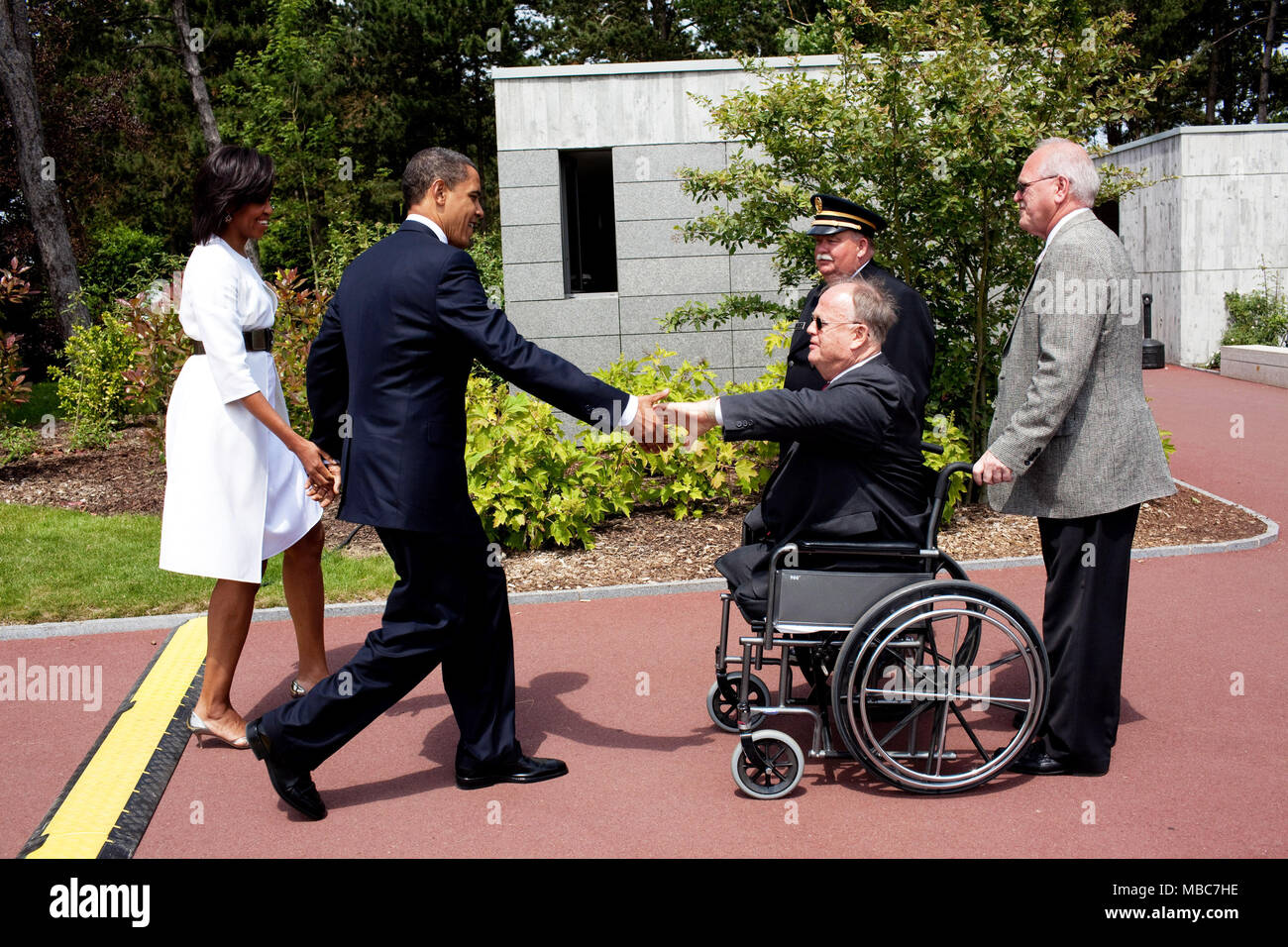 President Barack Obama and First Lady Michelle Obama meet with former Senator Max Cleland of Georgia during the memorial service at the Normandy American Cemetery in Colleville-sur-Mer, France, on the 65th anniversary of the D-Day landings, June 6, 2009    (Official White House photo by Pete Souza)  This official White House photograph is being made available for publication by news organizations and/or for personal use printing by the subject(s) of the photograph. The photograph may not be manipulated in any way or used in materials, advertisements, products, or promotions that in any way sug Stock Photo