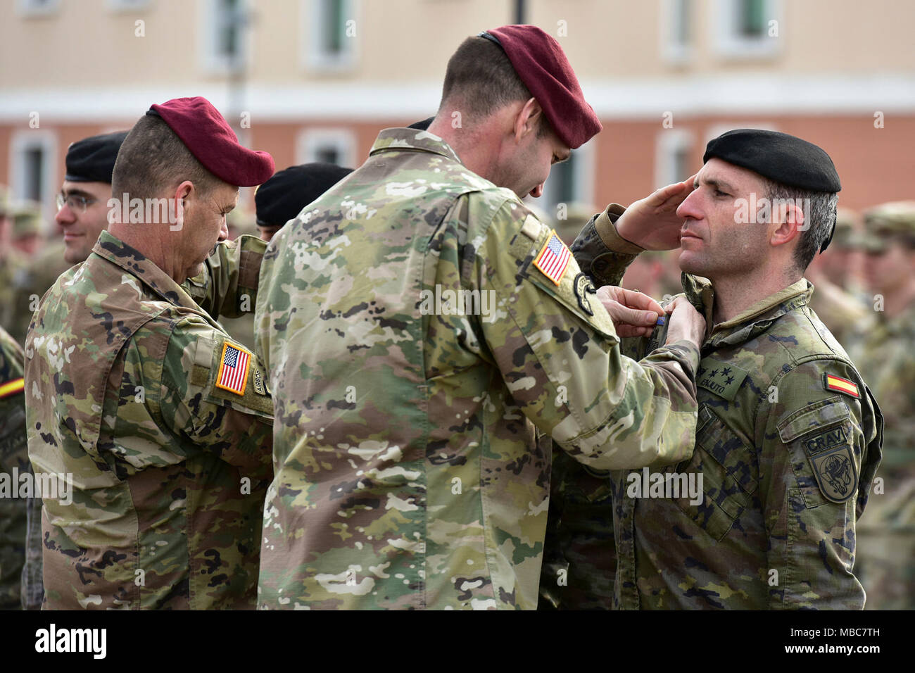 Col. James B. Bartholomees III, Commander of the 173rd Airborne Brigade (right) and Command Sgt. Maj. Franklin Velez of the 173rd Airborne Brigade (left), pin Expert Infantryman Badge’s (EIB) on Spanish Army Soldiers during Expert Infantryman Badge (EIB) ceremony at Caserma Del Din, Vicenza, Italy, 15 Feb. 2018. (U.S. Army Stock Photo