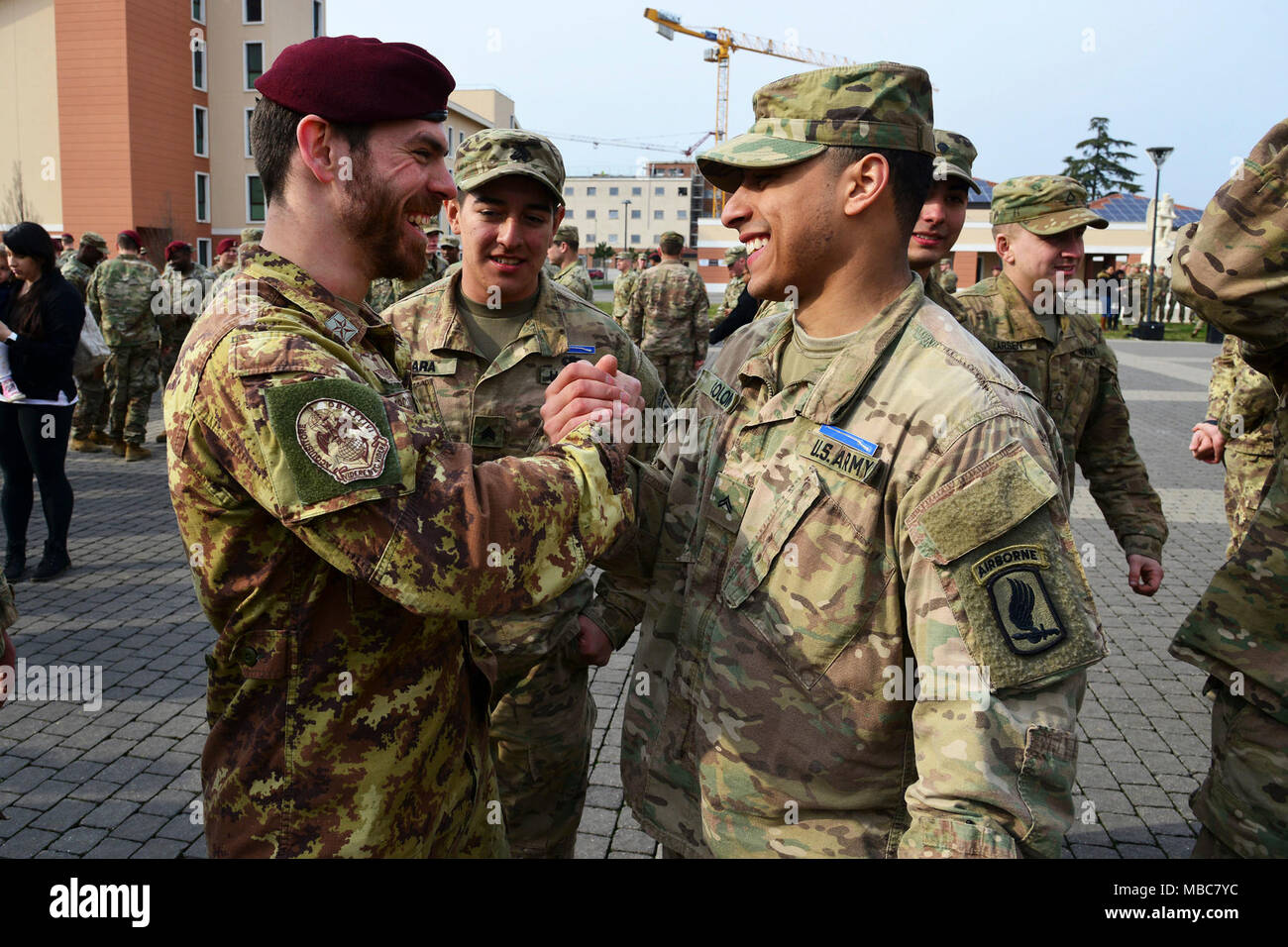 An Italian Army Soldier (left) and a U.S. Army Paratrooper assigned to the 173rd Airborne Brigade (right), say goodbye during the Expert Infantryman Badge (EIB) ceremony at Caserma Del Din, Vicenza, Italy, 15 Feb. 2018. (U.S. Army Stock Photo