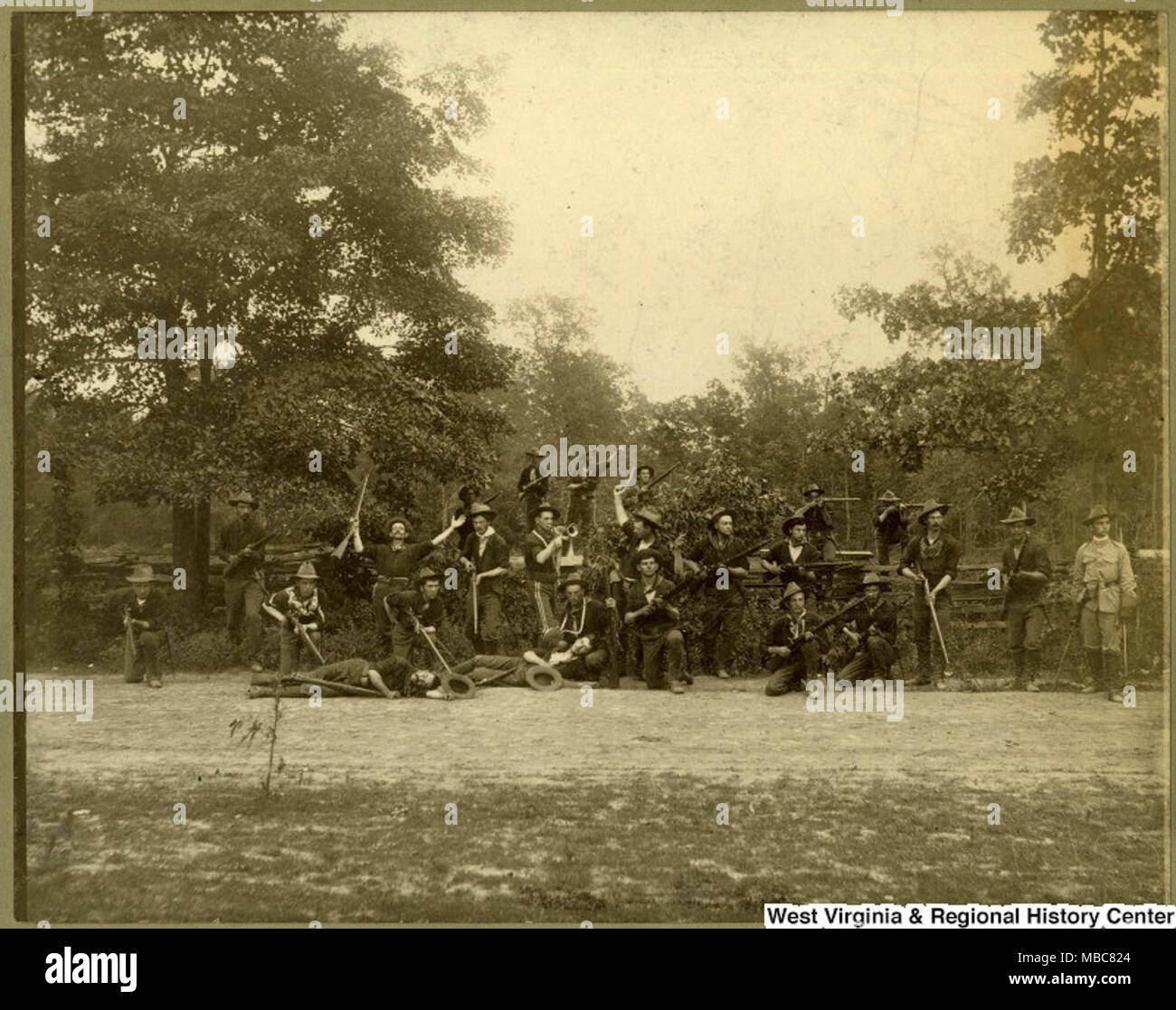The First West Virginia Infantry was a National Guard unit stationed in Georgia during the Spanish and American War from 1898-1899. The unidentified soldiers in this photograph pretend action to defend their position from an attack. Stock Photo