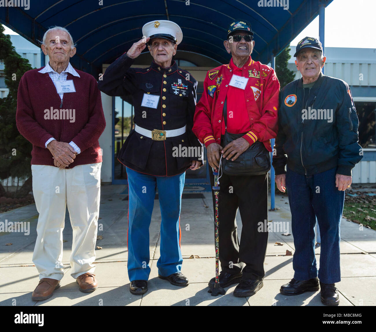 U.S. Marine Corps Iwo Jima veterans pose for a group photo during a tour of Marine Corps Base Camp Pendleton in commemoration of the 73d Anniversary of the Battle of Iwo Jima, Feb 15, 2018. Iwo Jima was a major World War II battle in which the United States Marine Corps landed on and eventually captured the island of Iwo Jima from the Japanese Imperial Army. Veterans of the battle and their family members were invited to Camp Pendleton for a tour which included a special reaction team static display, Meal Ready to Eat sampling, and a tour of the Assault Craft Unit-5. (U.S. Marine Corps Stock Photo