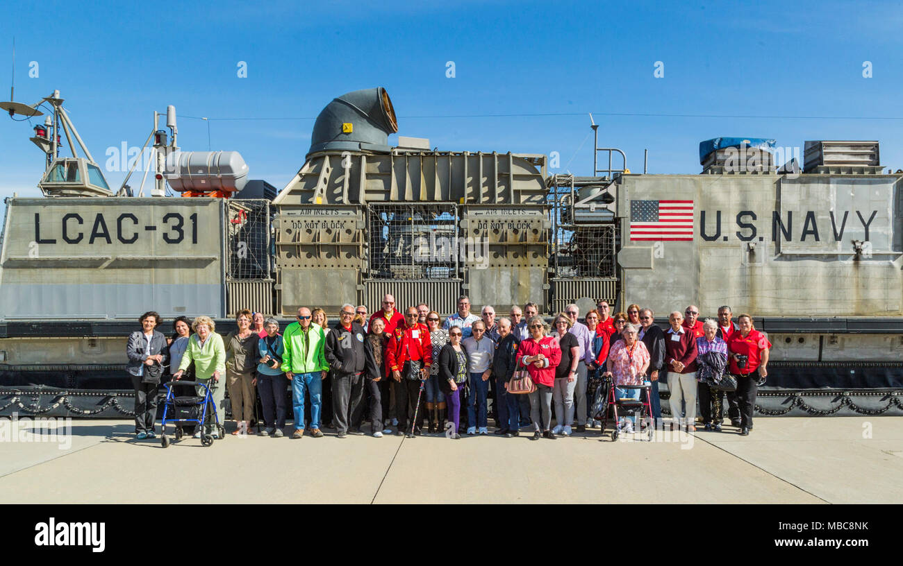 Iwo Jima veterans and their families pose for a group photo during a tour of Marine Corps Base Camp Pendleton in commemoration of the 73d Anniversary of the Battle of Iwo Jima, Feb 15, 2018. Iwo Jima was a major World War II battle in which the United States Marine Corps landed on and eventually captured the island of Iwo Jima from the Japanese Imperial Army. Veterans of the battle and their family members were invited to Camp Pendleton for a tour which included a special reaction team static display, Meal Ready to Eat sampling, and a tour of the Assault Craft Unit-5. (U.S. Marine Corps Stock Photo