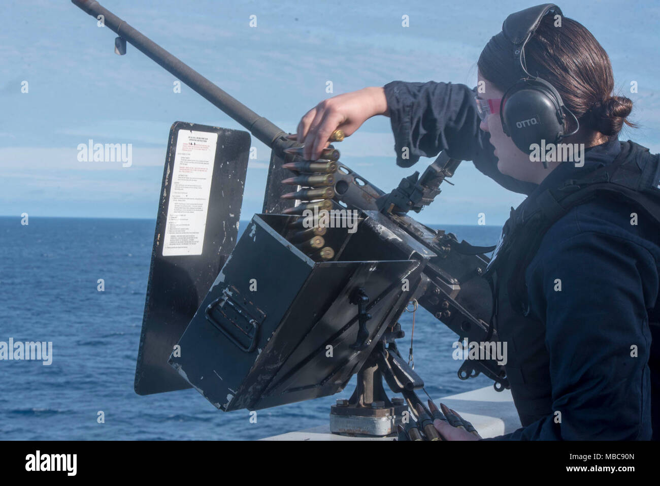 OCEAN (Feb. 15, 2018) Aviation Ordinance Airman Lindsey Cancel loads rounds into a M2HB .50-caliber machine gun on the bridgewing of the amphibious transport dock ship USS New York (LPD 21).  The Iwo Jima Amphibious Ready Group embarks the 26th Marine Expeditionary Unit and includes New York, the amphibious assault ship USS Iwo Jima (LHD 7), the dock landing ship USS Oak Hill (LSD 51), Fleet Surgical Team 8, Helicopter Sea Combat Squadron 28, Tactical Air Control Squadron 22, components of Naval Beach Group 2 and the embarked staff of Amphibious Squadron 4. (U.S. Navy Stock Photo