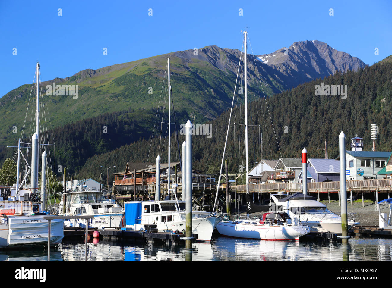 Boats in harbor and marina in the coastal Alaska mountain town of Seward Stock Photo