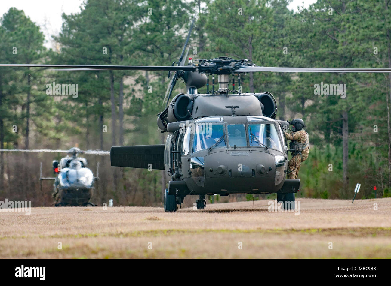A UH-60 Black Hawk from the South Carolina Army National Guard waits to take off and perform rescue hoist operations with the South Carolina Helicopter Aquatic Rescue Team during the exercise PATRIOT South 18 at Camp Shelby, Miss. on Feb. 15, 2018. PATRIOT South is a joint-agency, domestic operations exercise, focused on natural disaster preparedness and includes National Guard and civilian first responder units from across the country. (Ohio Air National Guard Stock Photo