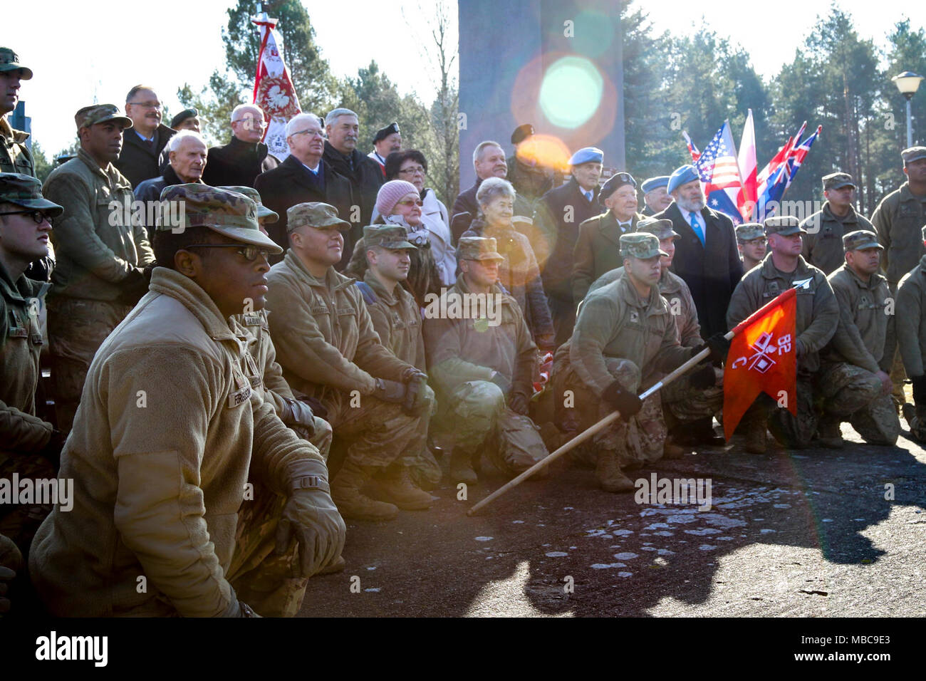 The Soldiers of Company C, 82nd Brigade Engineer Battalion, 2nd Armored Brigade Combat Team, 1st Infantry Division, and a collective of Polish families and veterans pose for a photo after a ceremony for the 73rd anniversary of the Battle of Zagan outside of the Stalag Luft III Prisoner Camp Museum in Zagan, Poland on Feb. 16, 2018. The U.S. Soldiers attended the event to strengthen Polish-American relationships during their deployment in support of Atlantic Resolve. (U.S. Army Stock Photo
