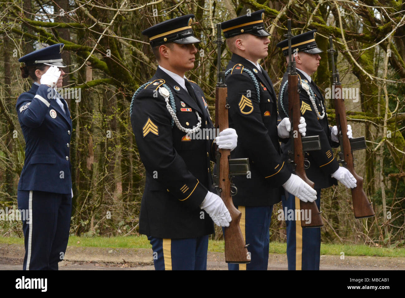 U.S. Air Force Staff Sgt. Kalene Kaplan (left) firing party commander ...