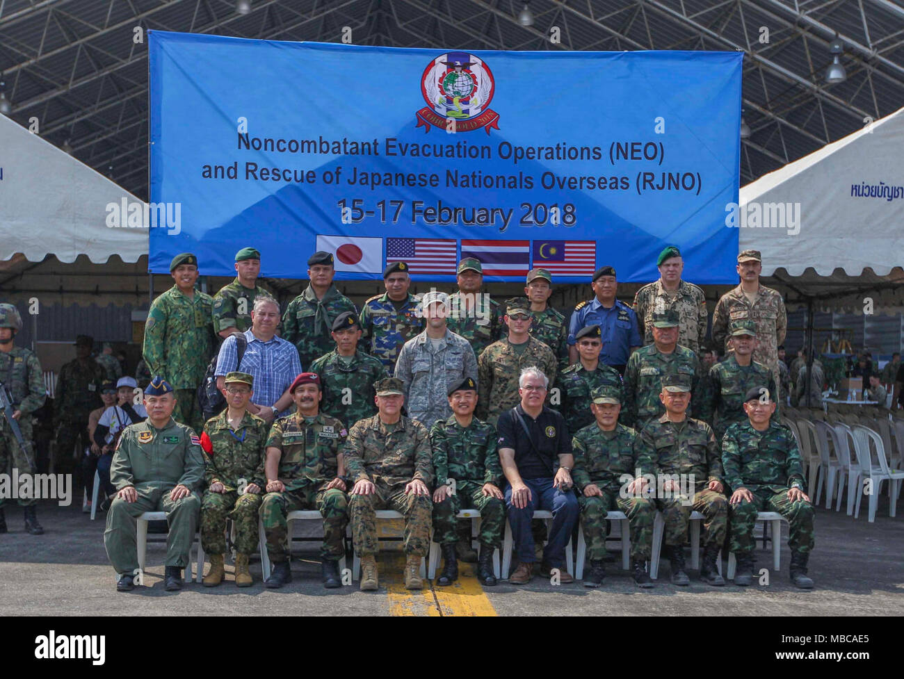 Commandant of the Marine Corps Gen. Robert B. Neller and other distinguished visitors pose for a photo during a Noncombatant Evacuation Operation (NEO) and Rescue of Japanese Nationals Overseas (RJNO) exercise, U-Tapao, Thailand, Feb. 17, 2018. NEO and RJNO exercises were held to ensure personnel readiness of multiple nations in the event of evacuation. (U.S. Marine Corps Stock Photo