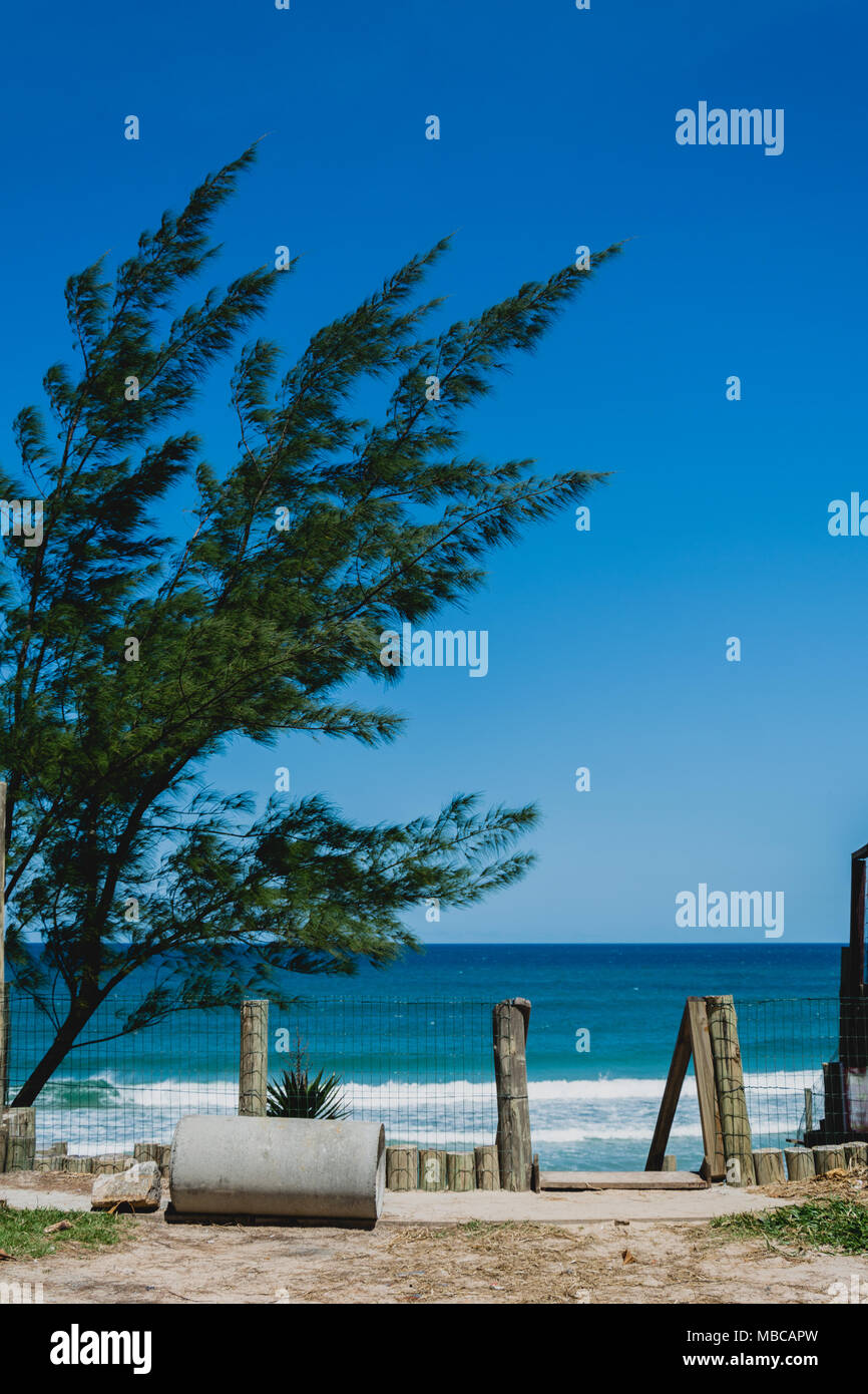 Florianopolis, Brazil. February, 2018. Narrow street with the sea at its end. Campeche Beach