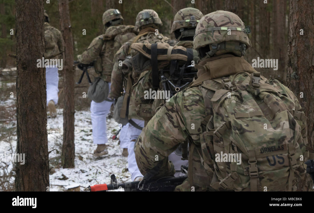 U.S. Soldiers assigned to Iron Troop, 3rd Squadron, 2nd Cavalry Regiment, ruck through the Polish forest to find and set up defensive positions while participating in the multinational training exercise Puma at a range near the Bemowo Piskie Training Area, Poland, Feb. 19, 2018. These Soldiers are part of the unique, multinational battle group comprised of U.S., U.K., Croatian and Romanian soldiers who serve with the Polish 15th Mechanized Brigade as a deterrence force in northeast Poland in support of NATO’s Enhanced Forward Presence. (U.S. Army Stock Photo