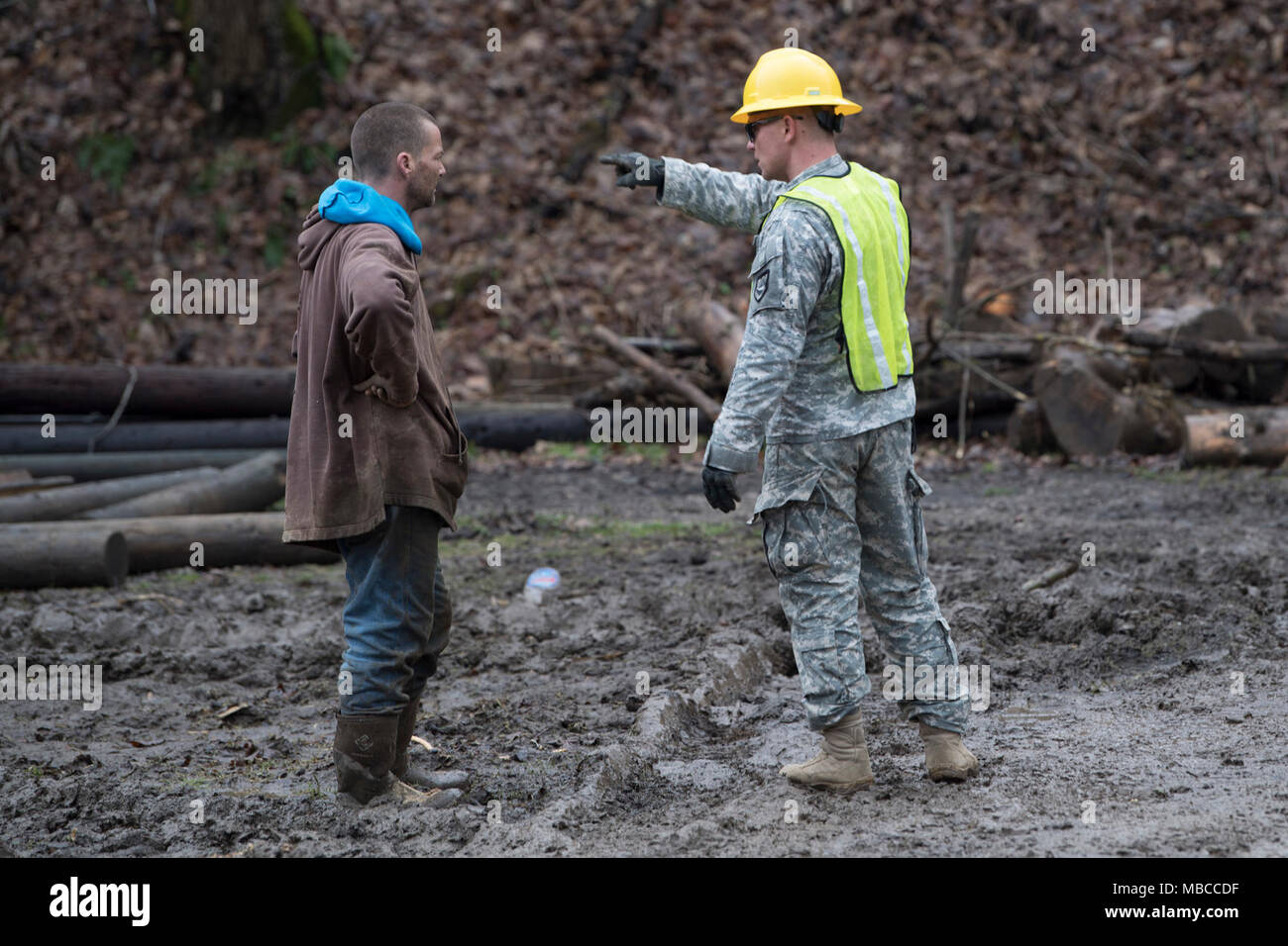 Staff Sgt. Kevin Smith, a combat engineer and non-commissioned officer in charge for the 119th Sapper Engineer Company, West Virginia National Guard, talks to a lcoal resident following flooding in Ohio County, West Virginia Feb. 19, 2018. WVNG Soldiers provided equipment for small and large debris removal and helped local residents and city crews to remove more than 128 tons of debris from the area. (U.S. Air National Guard Stock Photo