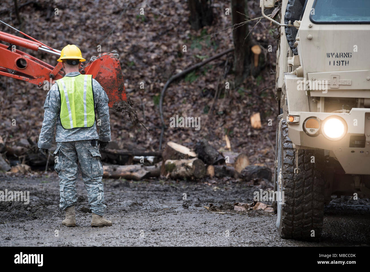Staff Sgt. Kevin Smith, a combat engineer and non-commissioned officer in charge for the 119th Sapper Engineer Company, West Virginia National Guard, watches as crews load heavy debris into trucks following flooding in Ohio County, West Virginia Feb. 19, 2018. WVNG Soldiers provided equipment for small and large debris removal and helped local residents and city crews to remove more than 128 tons of debris from the area. (U.S. Air National Guard Stock Photo