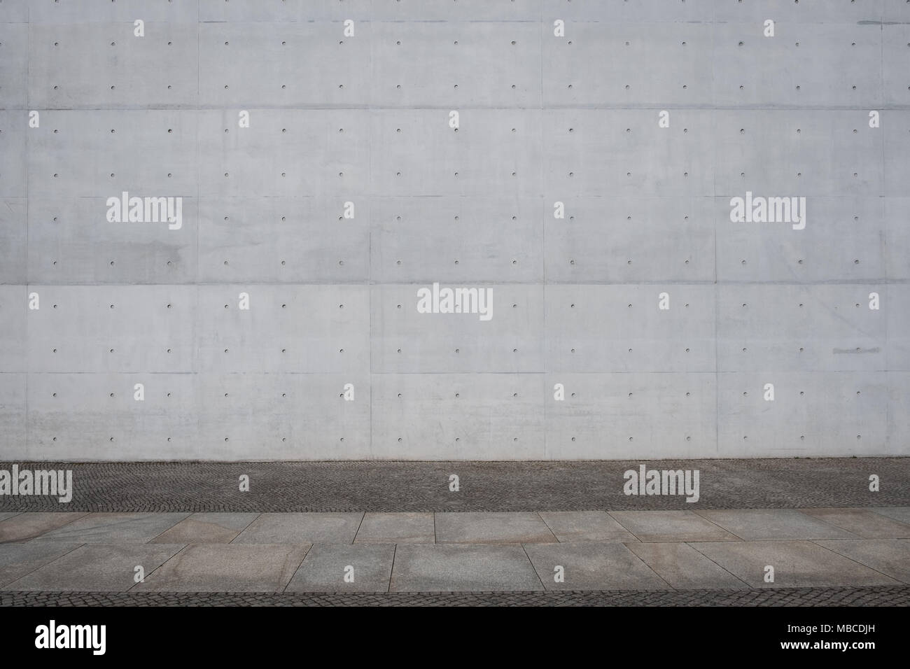 Sidewalk and exposed concrete wall background - concrete slabs - Stock Photo