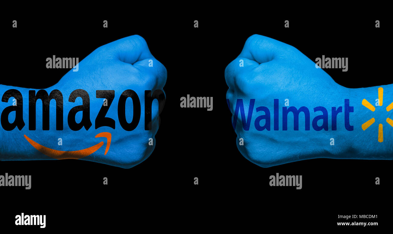 SAN ANTONIO, TX - APRIL 9, 2018 - Amazon and Walmart logos painted on two clenched fists facing each other/concept of retail war between Amazon and Wa Stock Photo