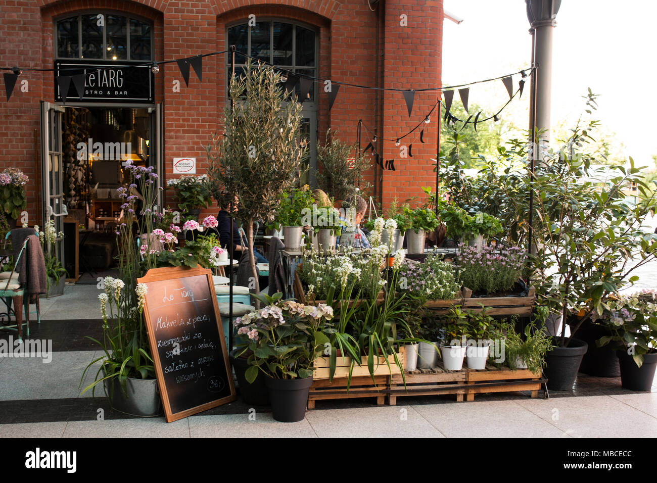 Outside a florist's shop at Stary Browar, an old brewery converted to a shopping center in Poznan, Poland. Stock Photo