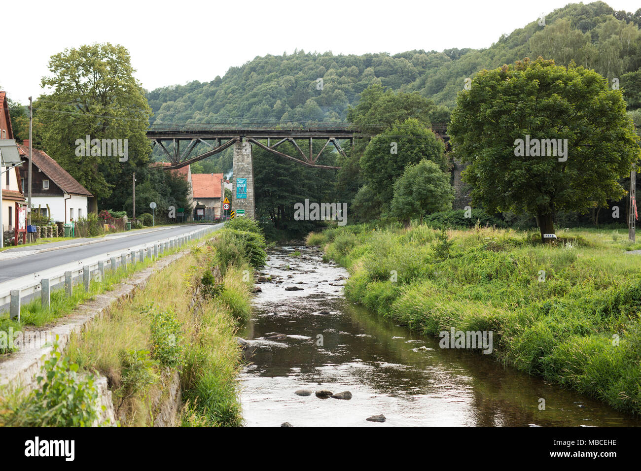 The Bystrzyca river runs under the viaduct on a summer evening in Jugowice, Poland. Stock Photo
