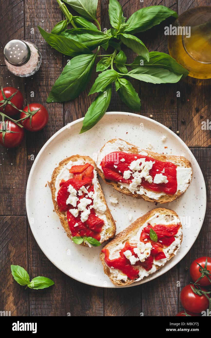 Bruschetta with roasted pepper and goat feta cheese, top view. Italian