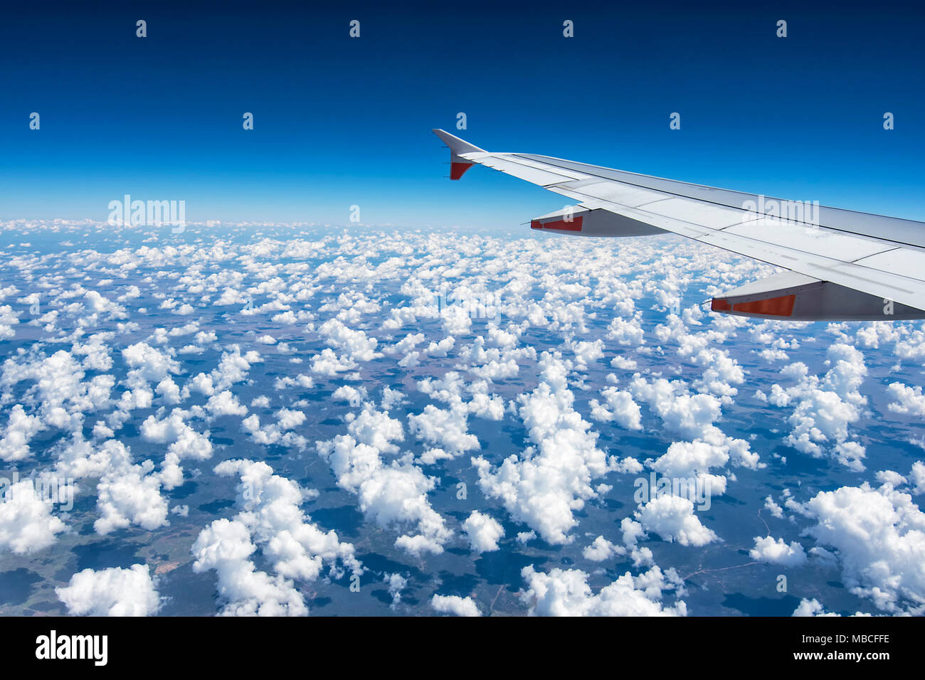 View Of Airplane Flying Over Clouds Stock Photos & View Of Airplane