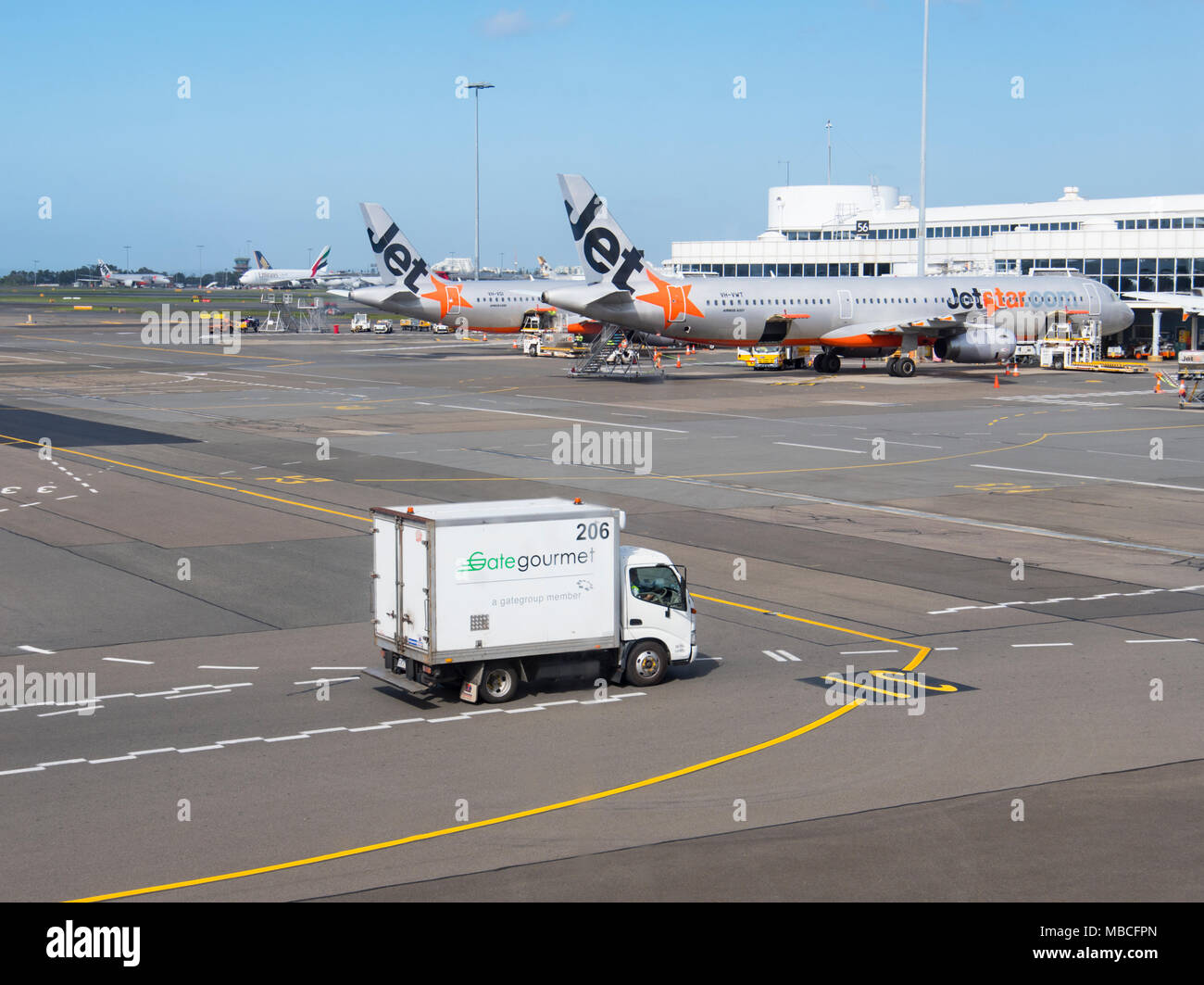 Gate Gourmet Catering Truck on the tarmac near Jetstar aircrafts at Sydney Airport, domestic terminal, Australia Stock Photo