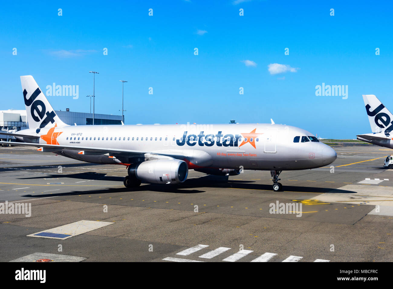 A Jetstar Airbus A320 aircraft taxiing on the tarmac at Sydney airport, domestic terminal, Australia Stock Photo