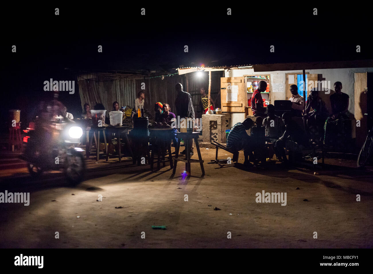 YONGORO, SIERRA LEONE - June 04, 2013: West Africa, group of unknown people in a bar at night in Yongoro Stock Photo