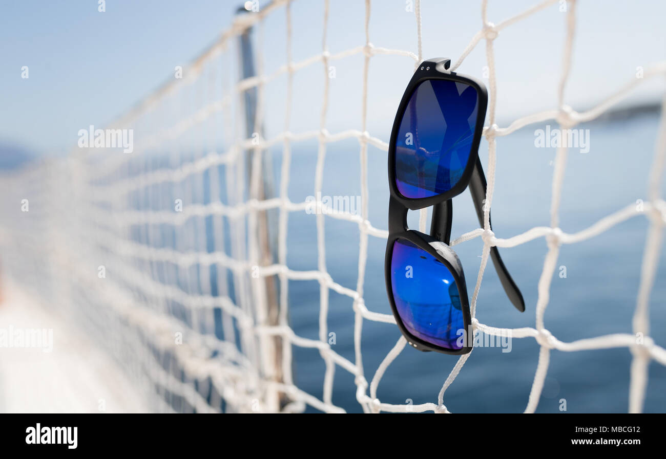 Picture of cool sunglasses hanging on net Stock Photo