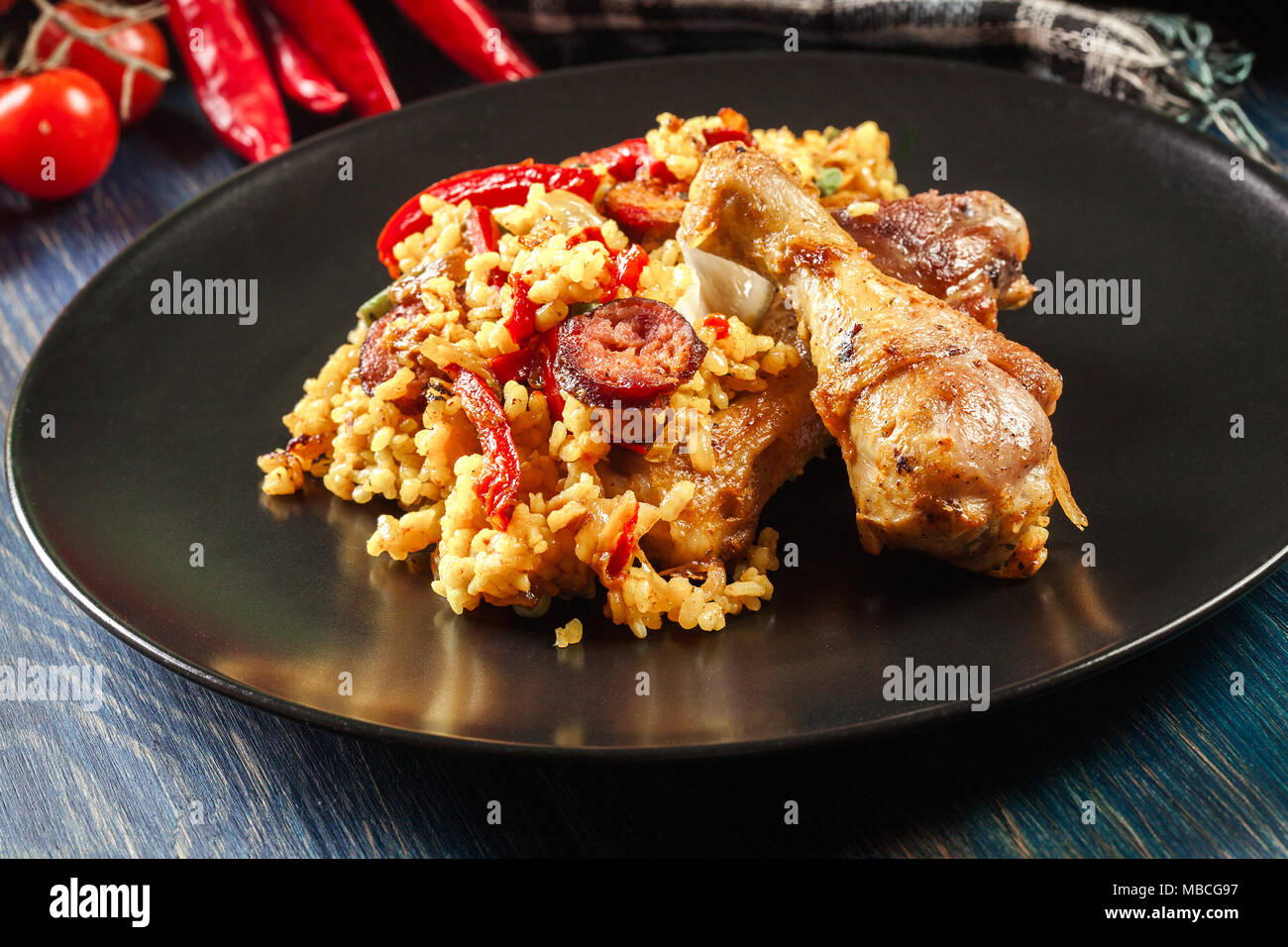 Traditional paella with chicken legs, sausage chorizo and vegetables