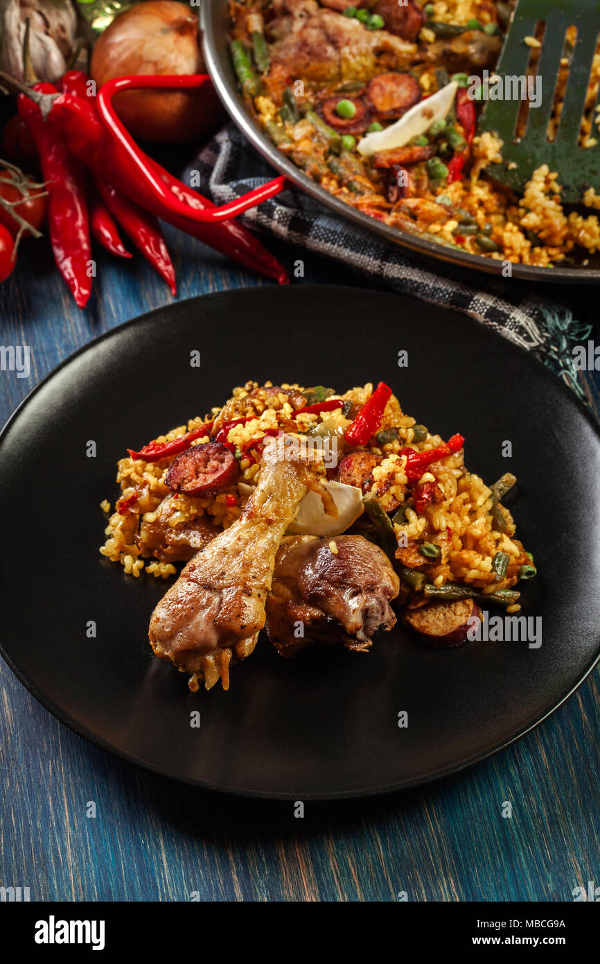 Traditional paella with chicken legs, sausage chorizo and vegetables