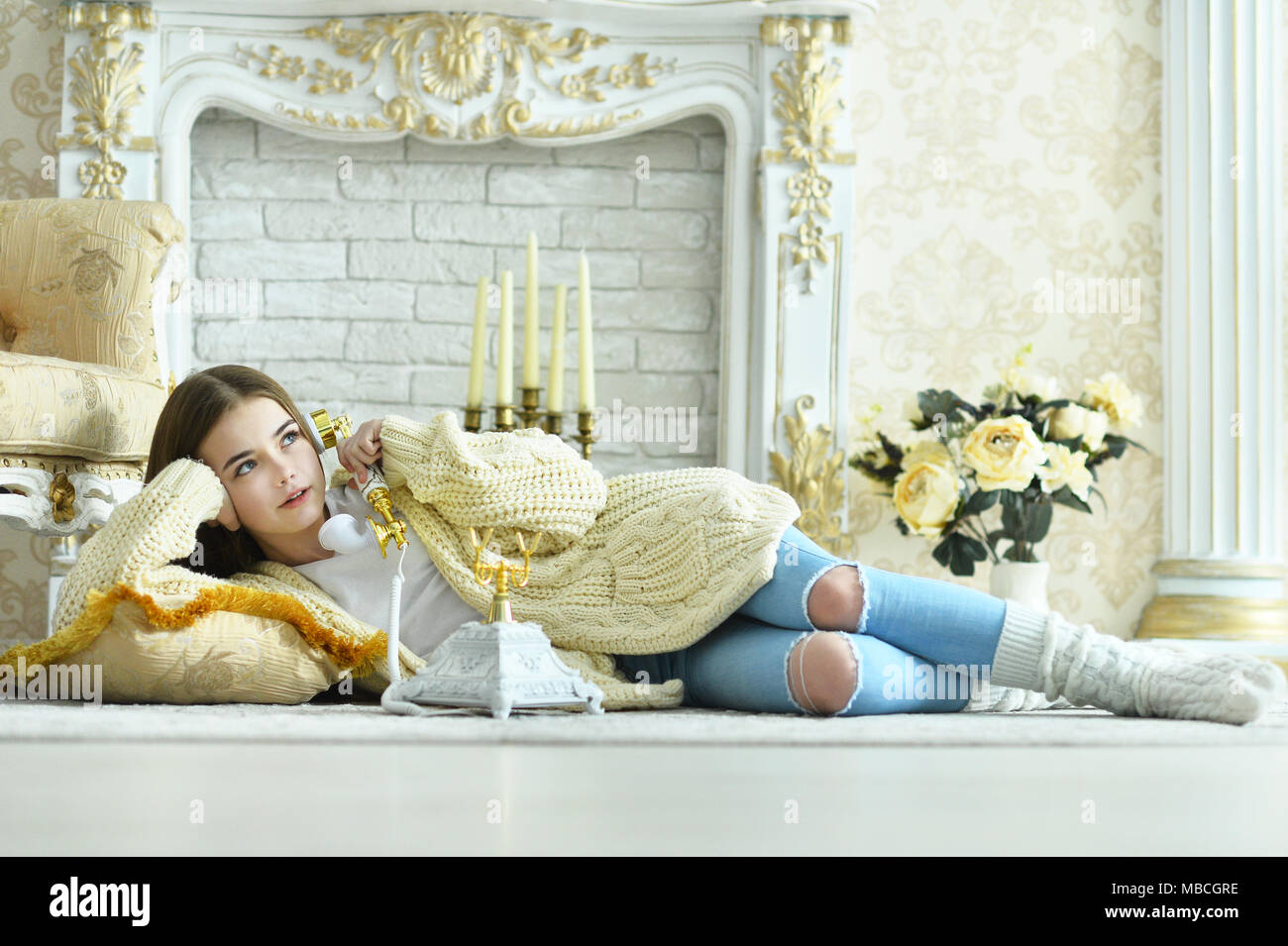 Beautiful teen girl lying on floor and talking on vintage phone Stock ...