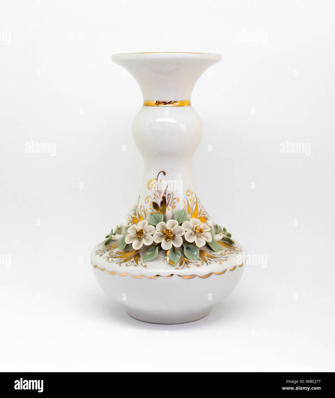White ceramic porcelain rich decorated vase with roses and gold pattern isolated on white background Stock Photo