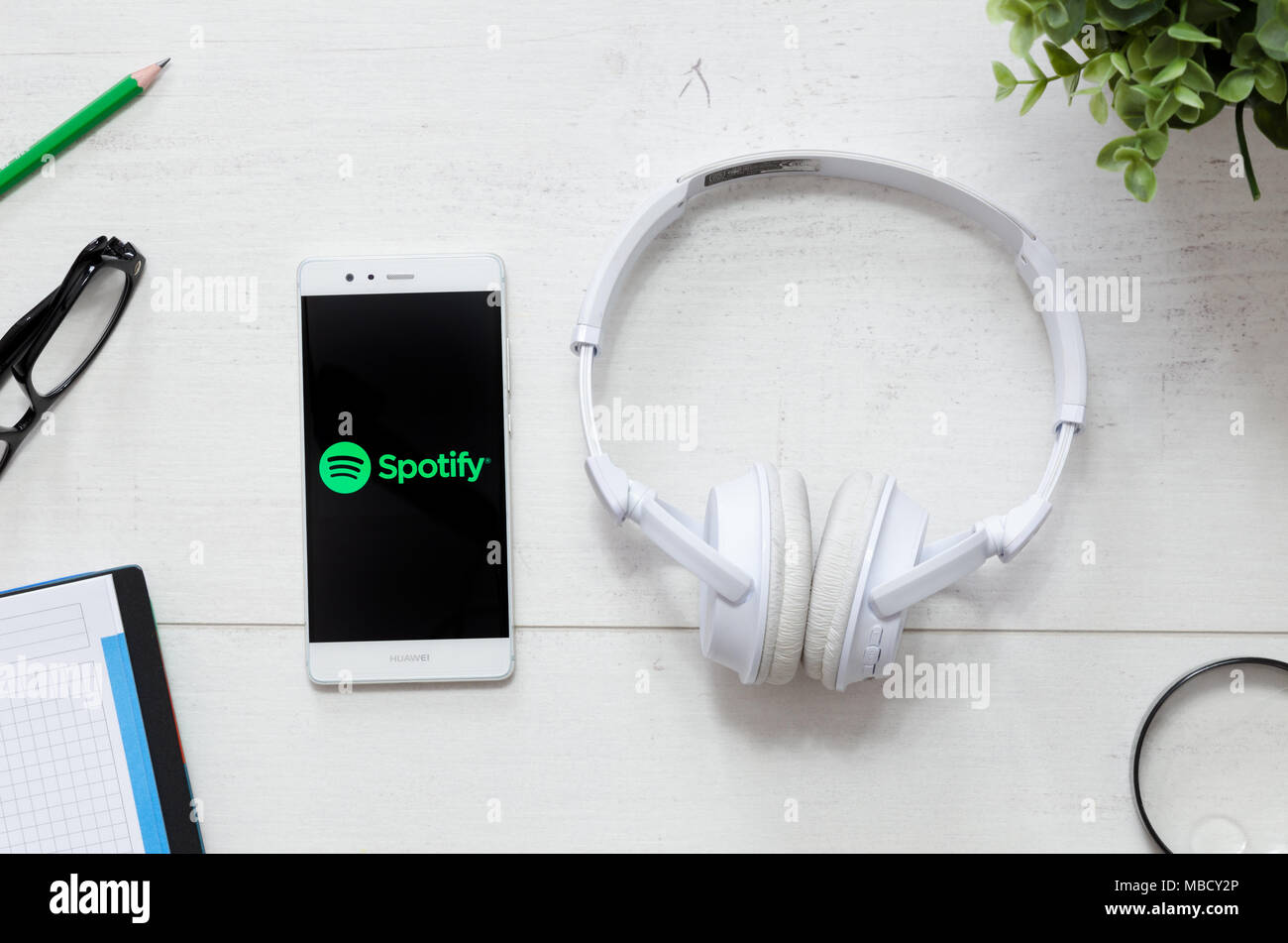 WROCLAW, POLAND - MARCH 29, 2018: Spotify is a music service that offers legal streaming music. Smartphone with Spotify logo on desk. Stock Photo