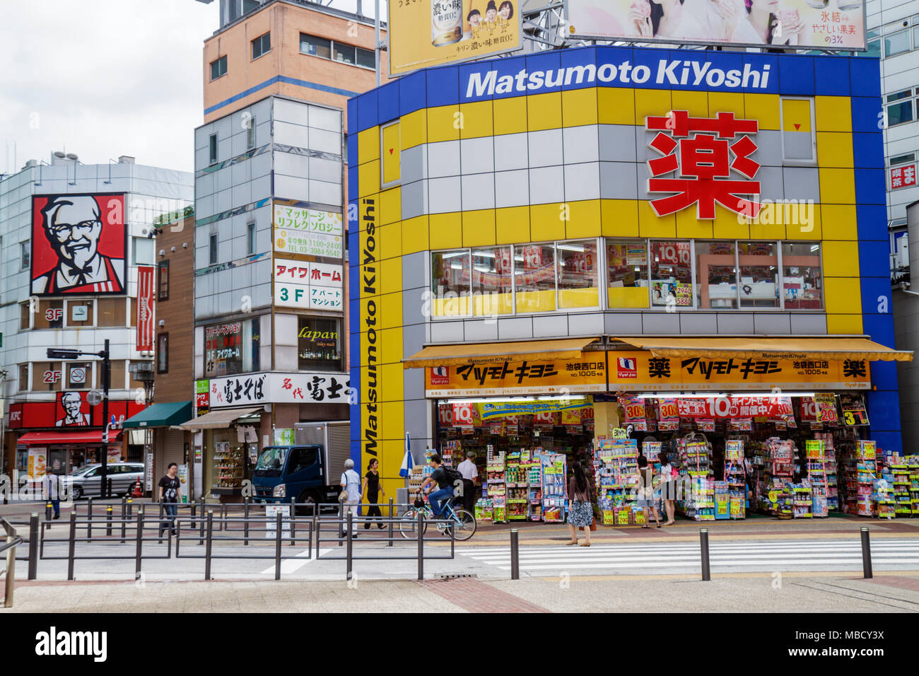 Tokyo Japan,Ikebukuro,businesses,district,kanji,Japanese English,street scene,Matsumoto Kiyoshi,pharmacy,drugstore,KFC Kentucky Fried Chicken,fast foo Stock Photo