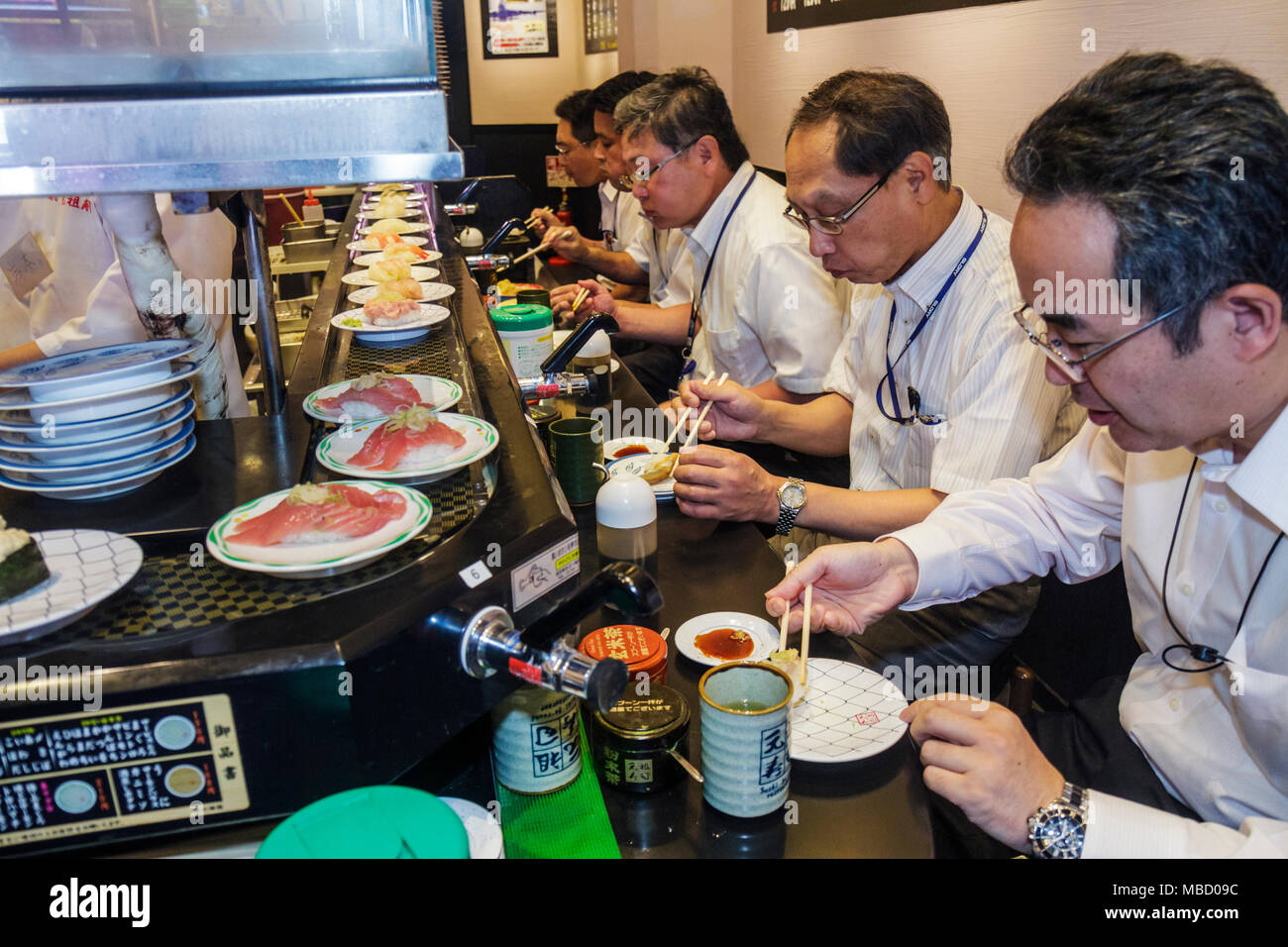 Tokyo Japan,Akihabara,Electric Town,Chuo Dori Street,kanji,sushi bar,restaurant restaurants food dining cafe cafes,conveyor belt,Asian Oriental,man me Stock Photo
