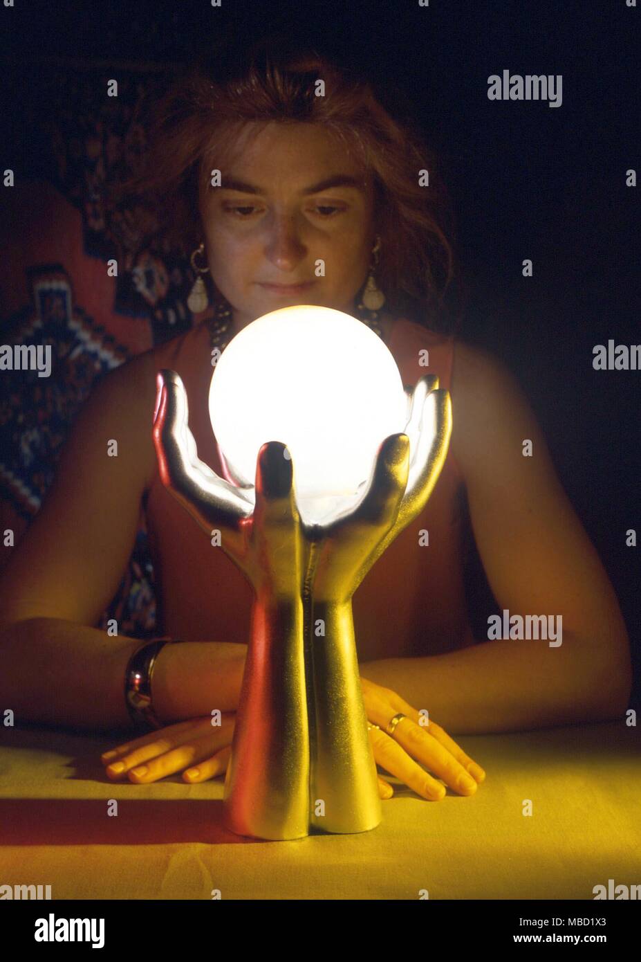Crystal gazing Woman practicing the art of scrying by gazing into a