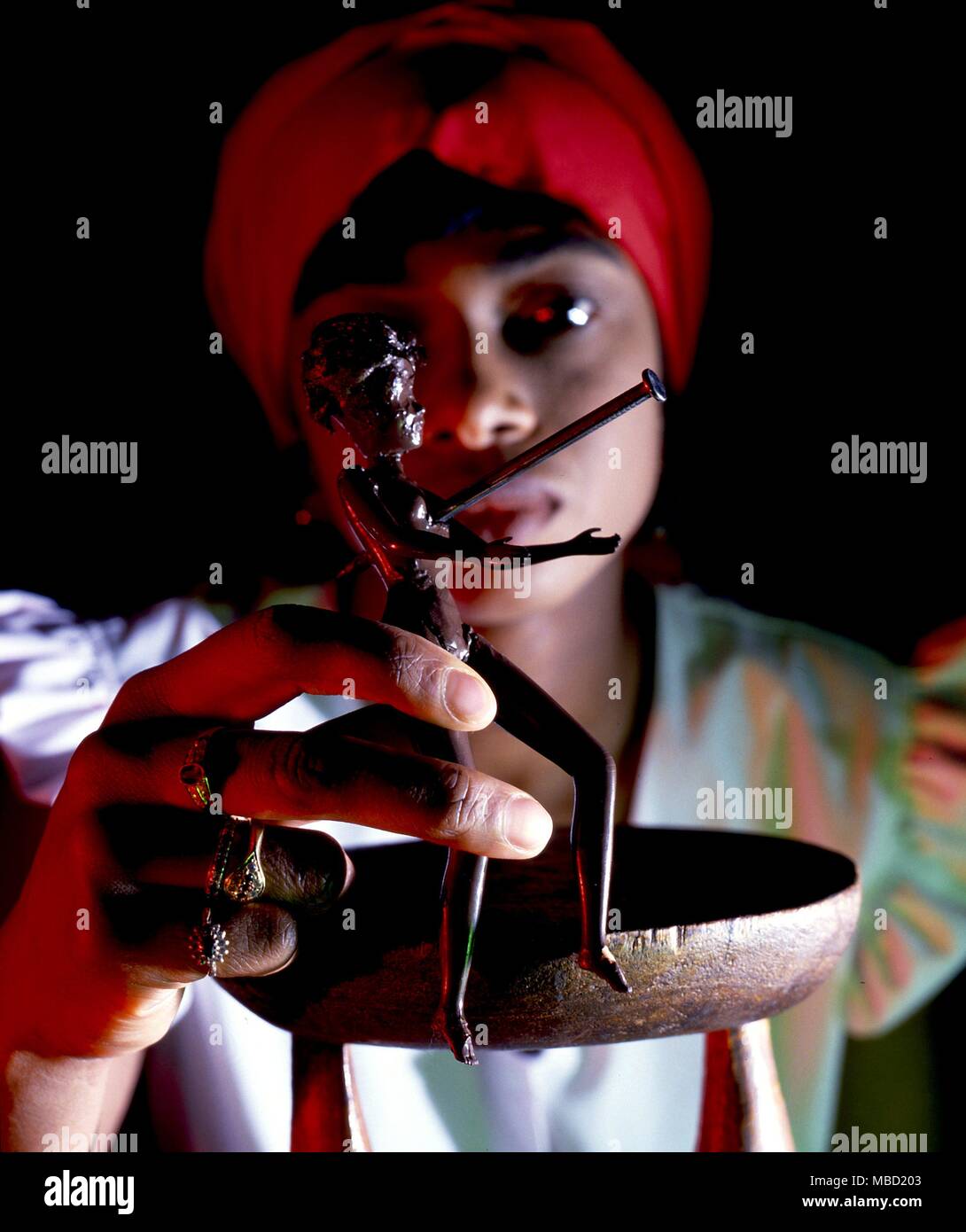 Voodoo poppet (witchcraft doll) nailed through as in a ritual. Stock Photo