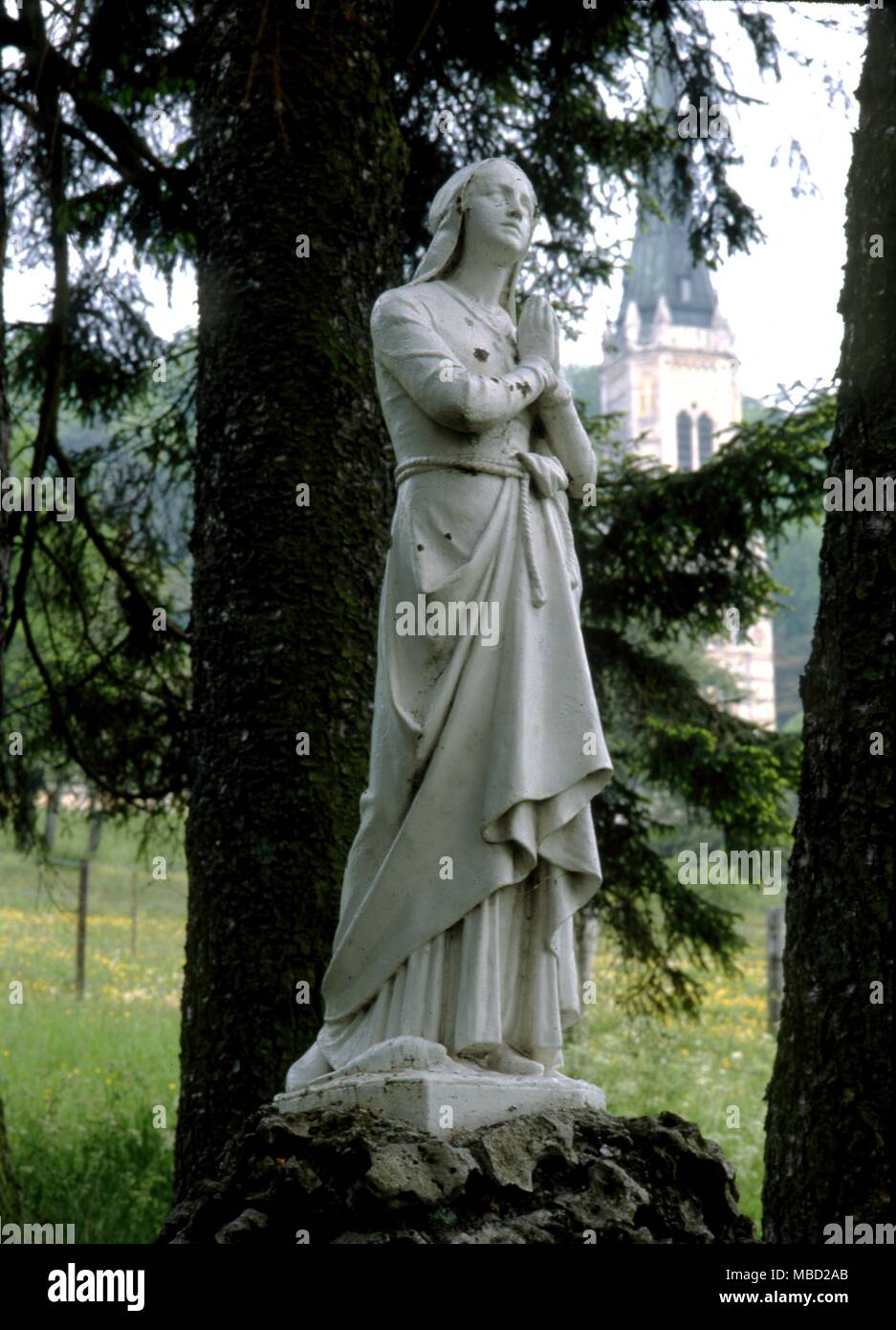 The fountain des Fievreux near the Basilique du Bois-Chenu, Domremy, is mentioned in The Trial of 1431. The fountain still gives water and is marked by a statue of Joan of Arc. Stock Photo