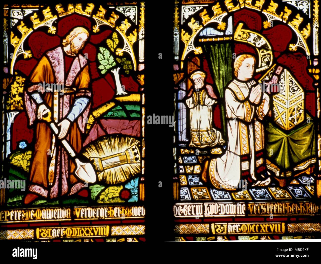 Bruges, Belgium. Stained glass window in the Chapel of the Holy Blood, shows the sacred blood of Jesus being buried in a phial to protect it. Stock Photo