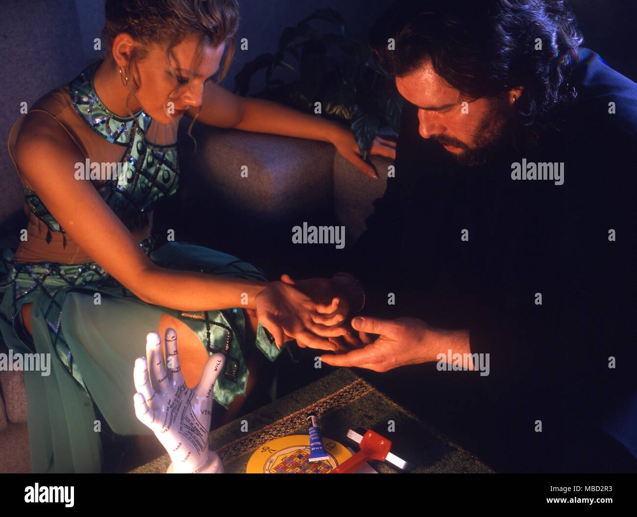 Palmistry - Man reading the hand of a young girl. In front of them is the apparatus for making palm-prints, which are such an important part of the palmistic approach to divination and character-reading.- © / CW Stock Photo