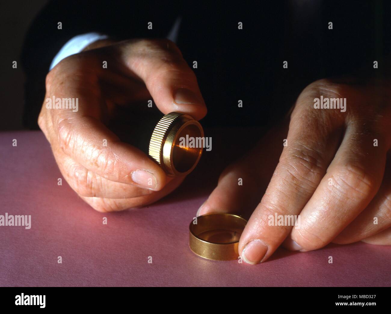 Stage Magic - Marvin's Magical Coins. Magician prepares to make coins reappear. Stock Photo