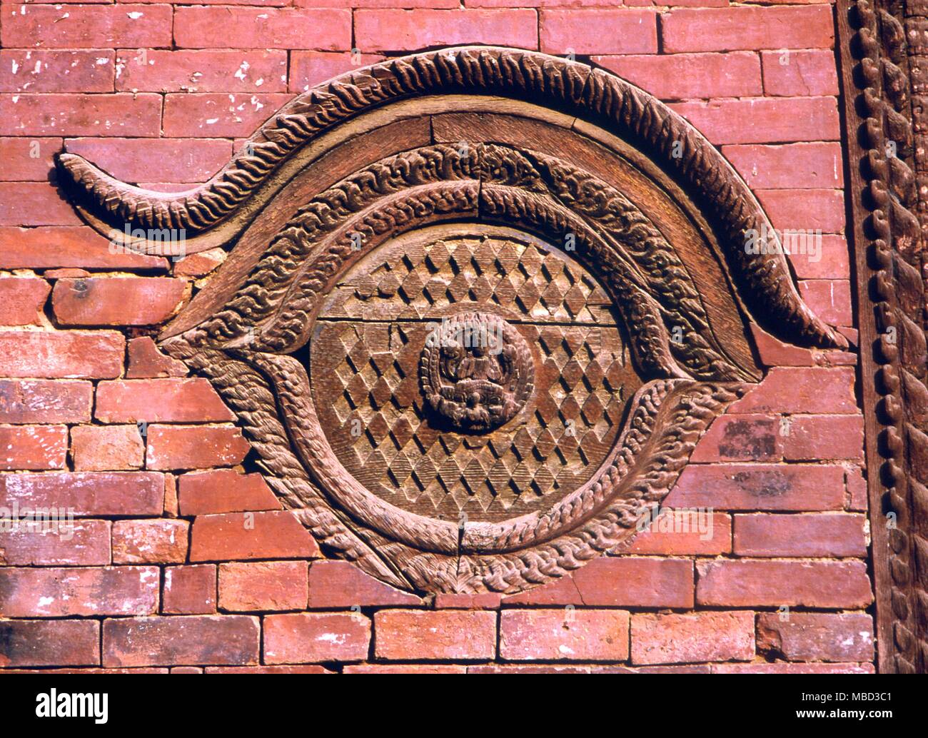 Symbols - Eye. Cosmic eye constructed in brickwork on a temple in Patan, Nepal. Stock Photo
