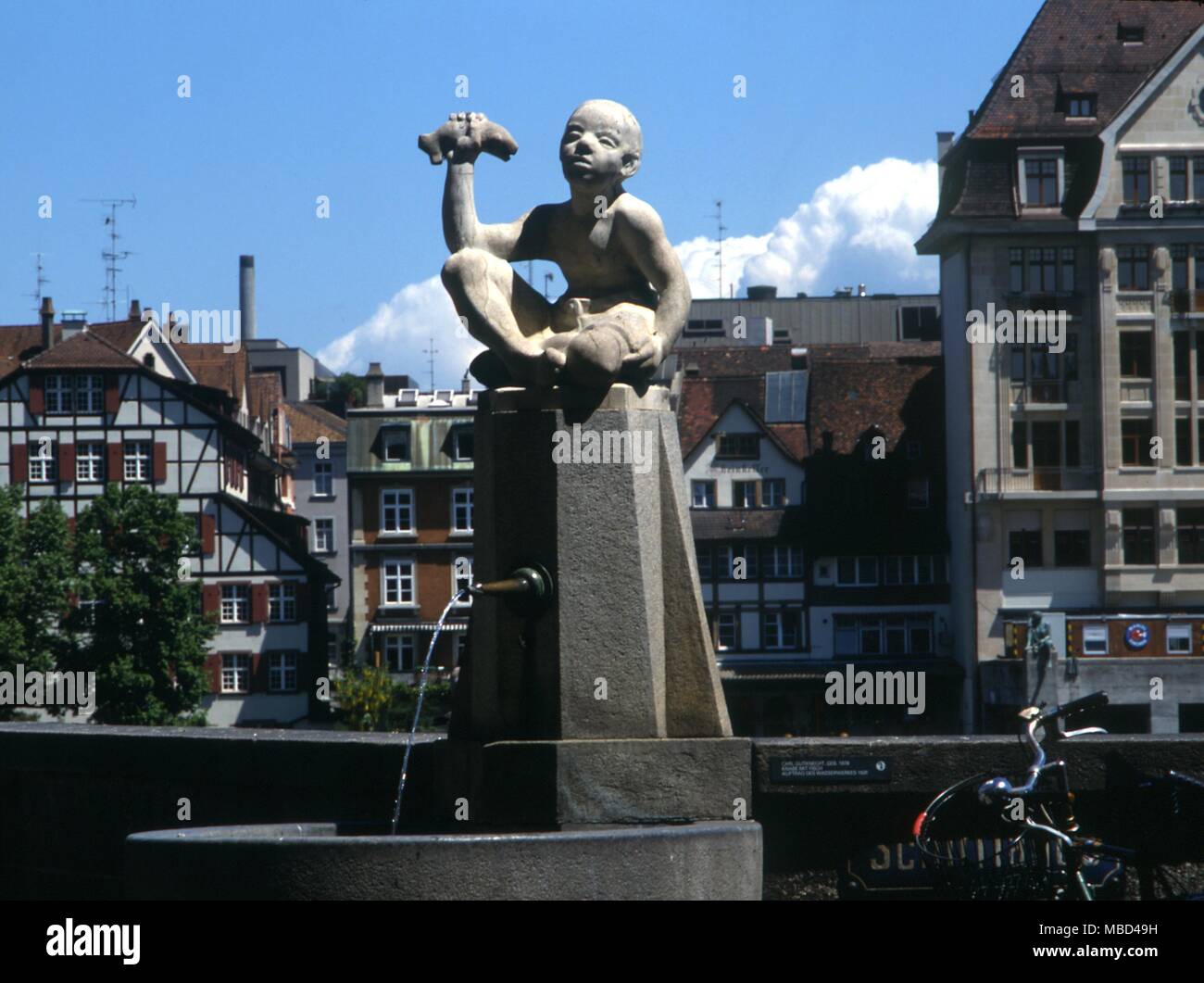 Elements - water - decorative fountain at Basle. The image of a boy eating a fish is of early mediaeval origin and unites the idea of water with the Eucharist. Christ was the Fish of the Piscean age.- ©Charles Walker / Stock Photo