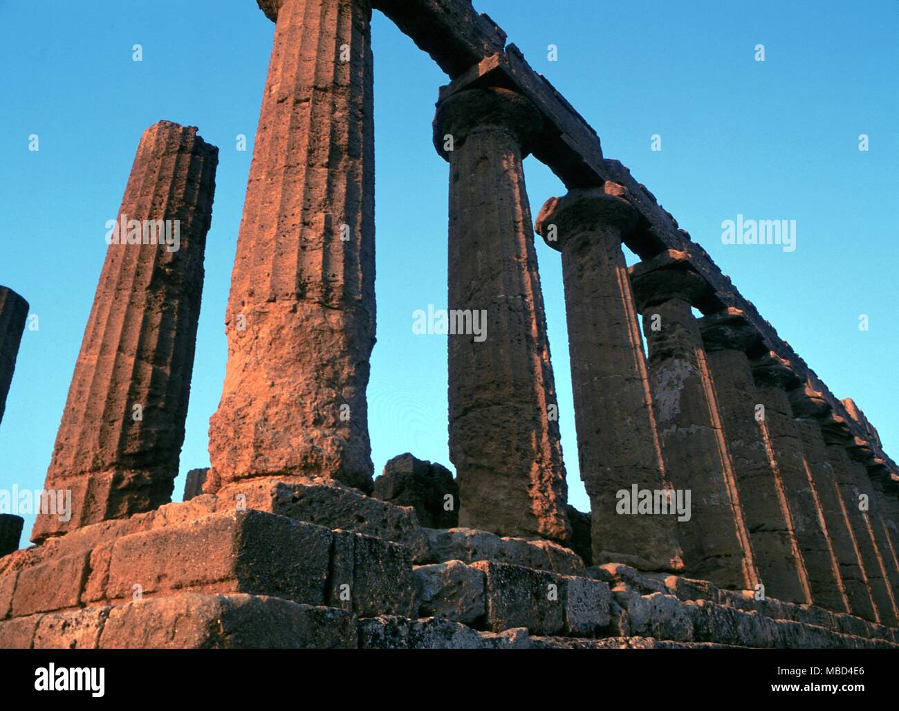 Greek Mythology. Temple of Juno. The Temple of Hera Lacinia, or Juno, at Agrigento, Sicily, built circa 440 BC. The shot has been taken to show how the first rays of sunrise (in August) strike the east end of the temple. Stock Photo