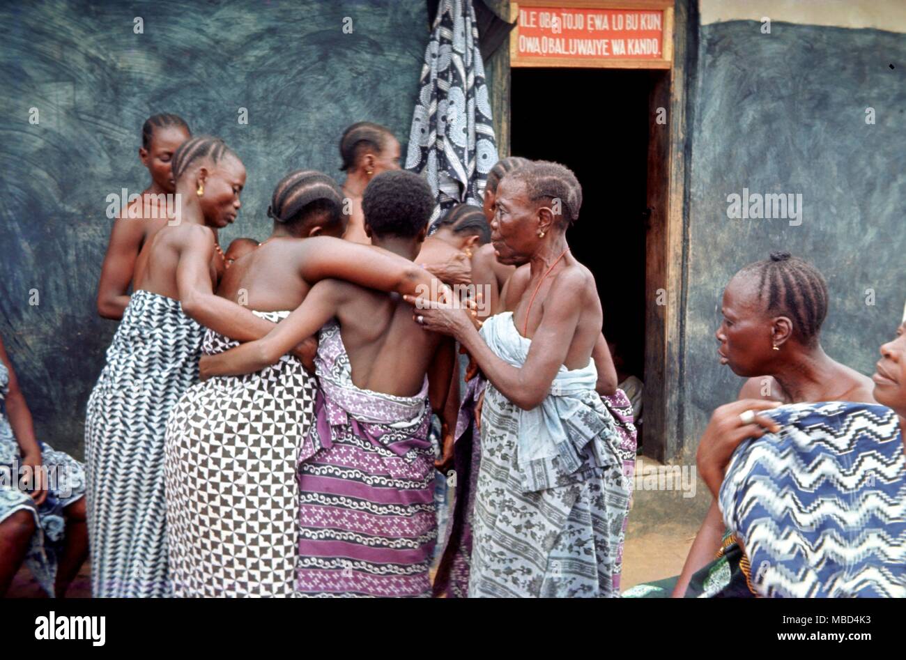 Hypnosis - Sopono worshippers under hypnosis from the local witchdoctor, being carried into a village house for safety. - Stock Photo