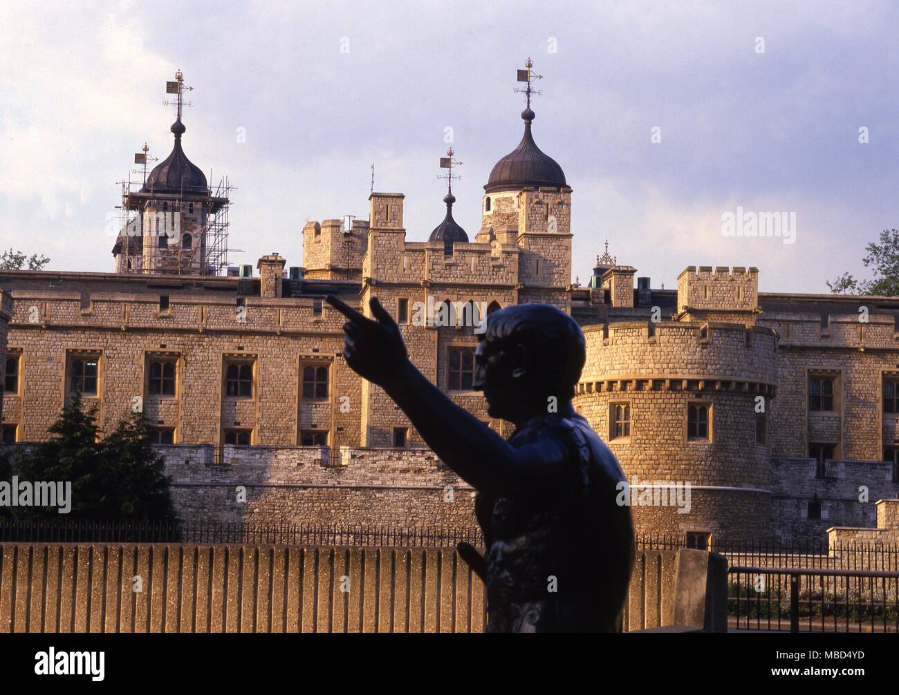 The Tower of London is said to be the most haunted castle in England. A view of the tower, with the bronze statue of the Roman Emperor, Hadrian, in the foreground Stock Photo